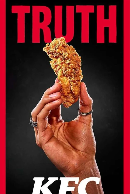 Hand holding fried chicken on a black background with red text reading 'Truth' and 'KFC', commercial food photography.