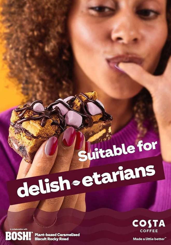 A woman holds a chocolate-covered caramel biscuit with marshmallows on top with text about being suitable for vegetarians.