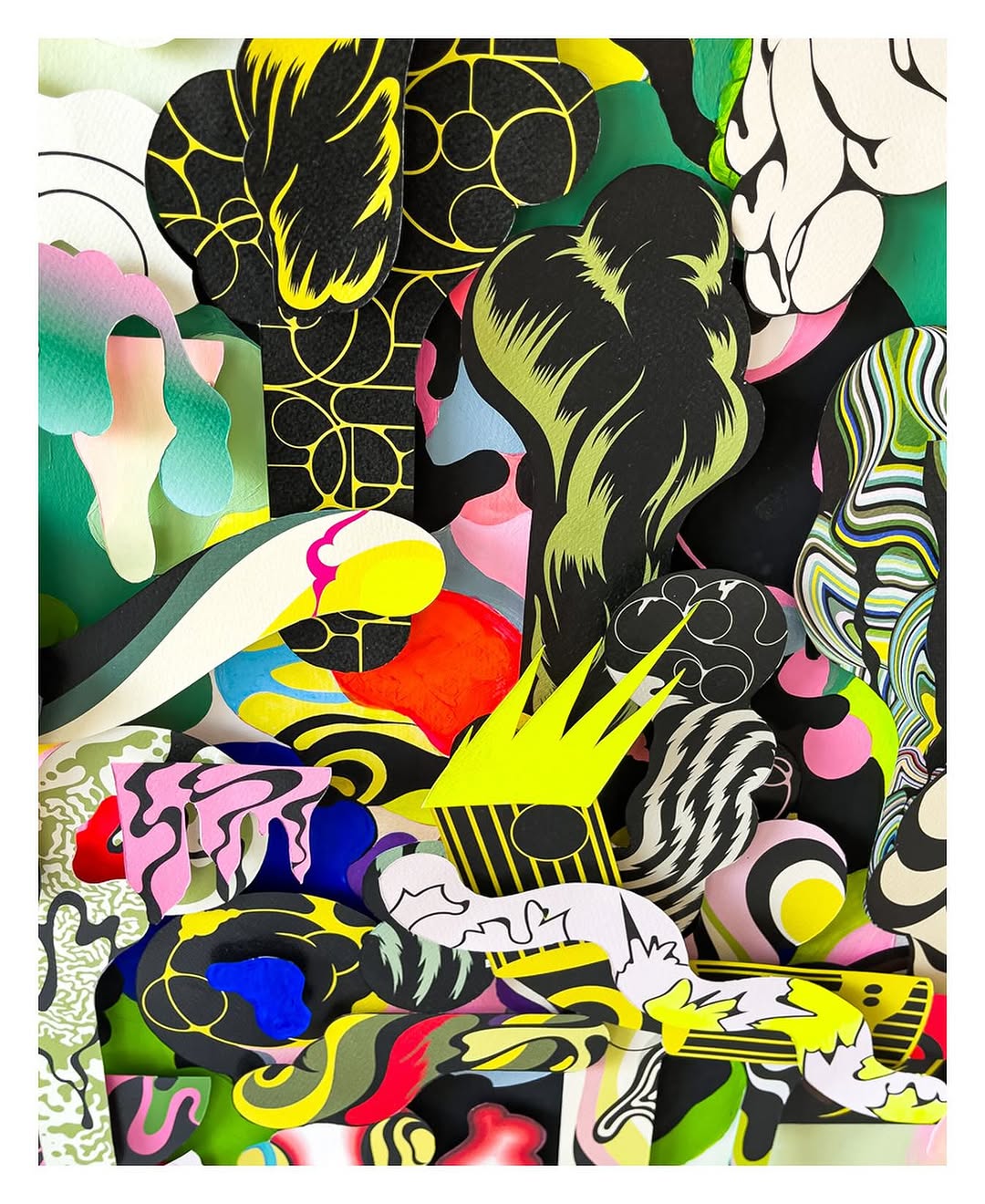 Dynamic abstract artwork features overlapping paper cutouts with bold colors, stripes, and geometric patterns creating depth and visual interest.