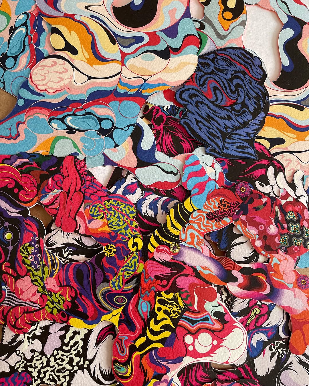 Abstract paper collage art featuring vibrant psychedelic patterns with shapes of dark blue, red, pink, yellow, turquoise, and black.