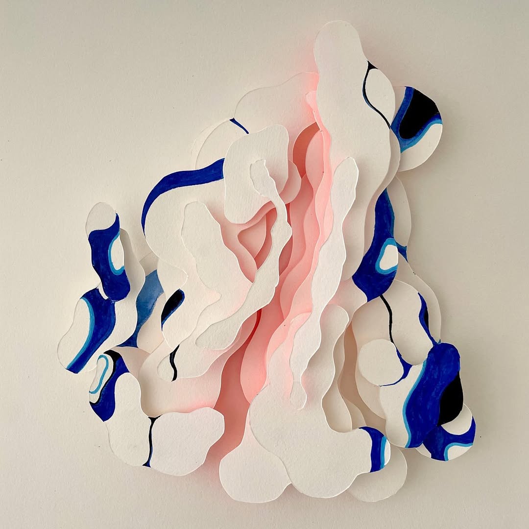 Abstract layered paper art with white, pink, and blue hues creates a modern, textured wall decoration for contemporary spaces.