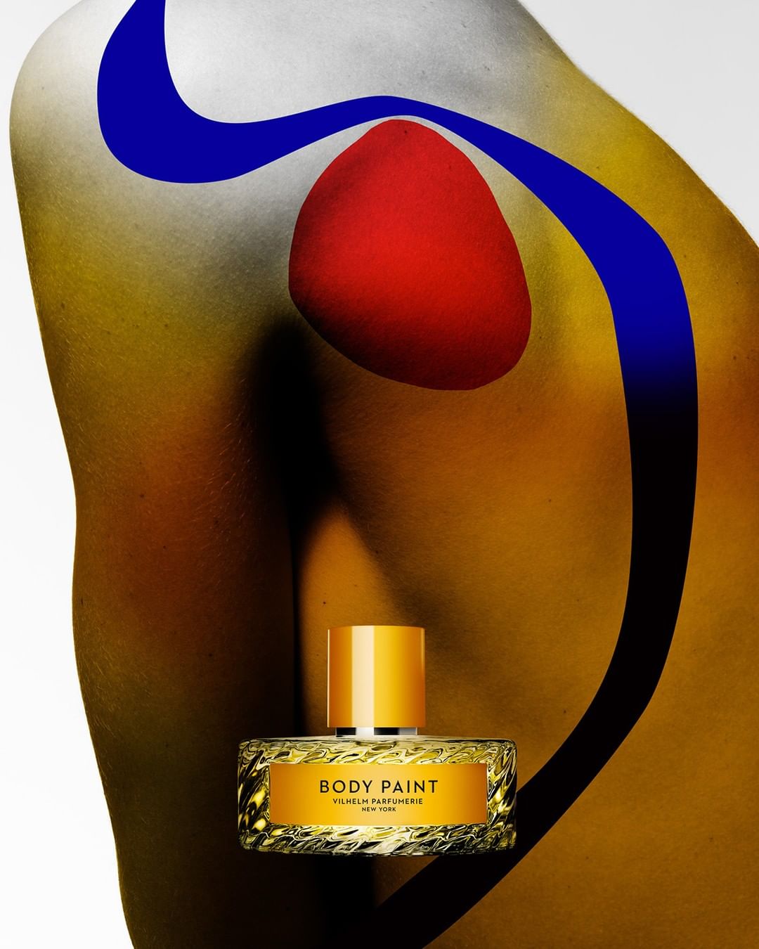 Body paint-themed perfume bottle, abstract red and blue body paint on the model's shoulder, studio setting, yellow and white background.