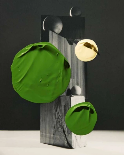 Abstract still life with green paint blobs and marble blocks. Features spheres, geometric shapes, and neutral color palette in a studio setting.