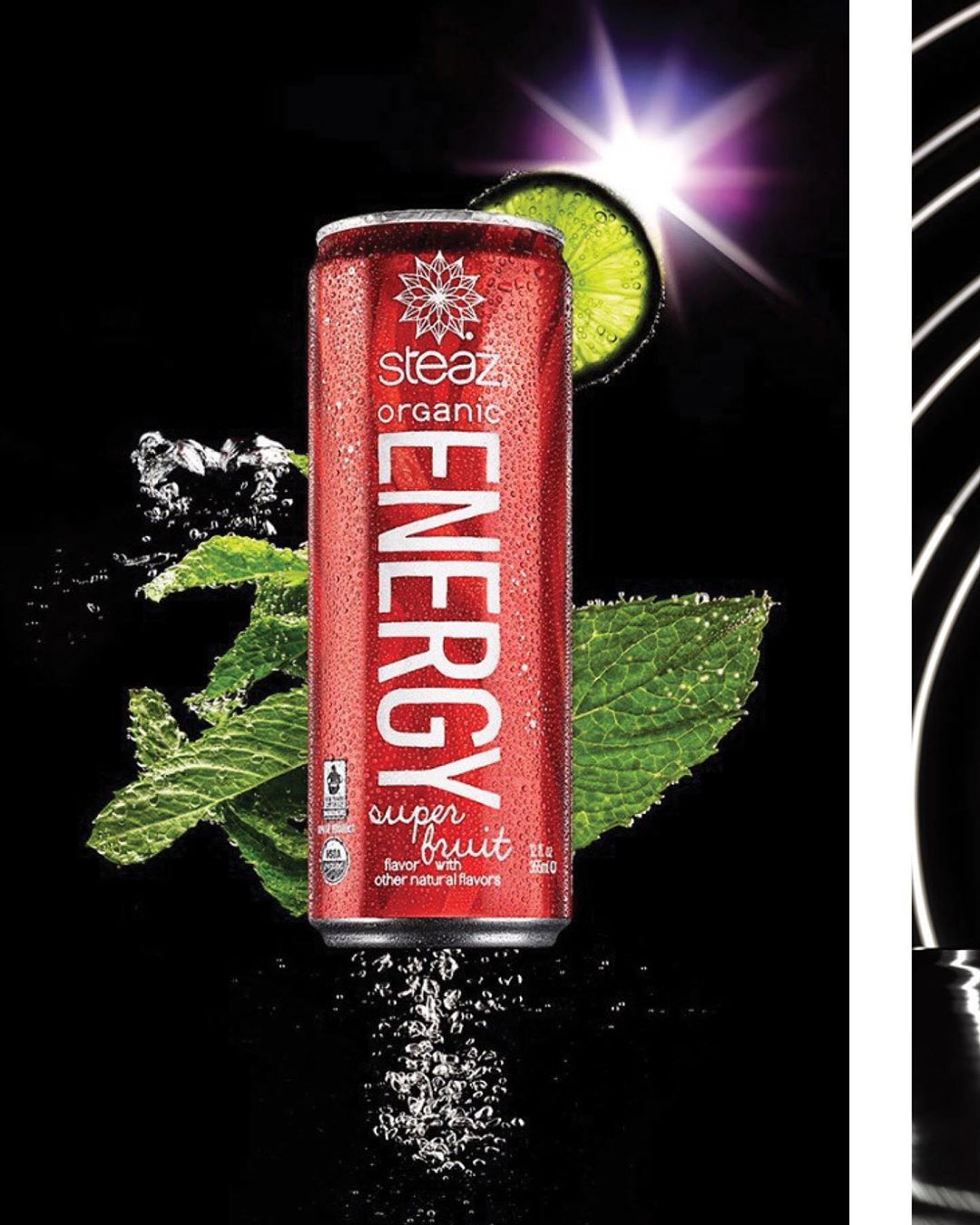 Red Steaz organic energy drink can with water droplets, lime wedge, and mint leaf against a black background with lighting effects.