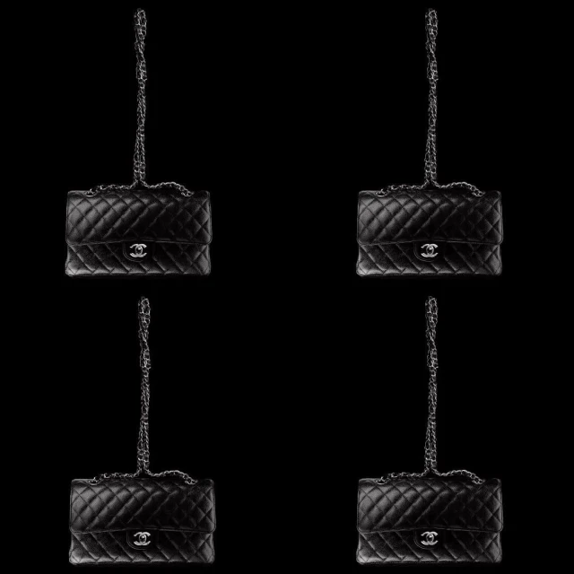 Four black quilted Chanel flap bags with silver chain straps arranged symmetrically against a solid black backdrop.