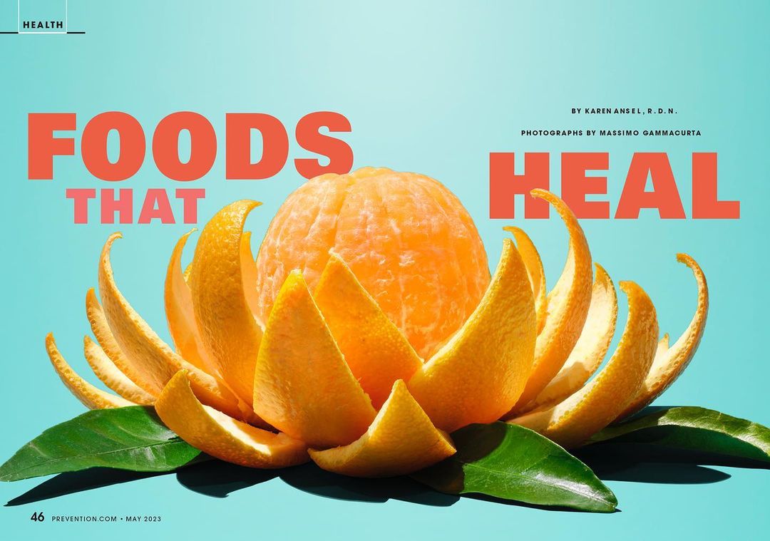 Magazine cover featuring a peeled orange arranged like a flower with green leaves against a light blue background, promoting healthy foods.