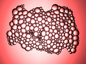 Close-up macro photography of translucent soap bubbles forming an organic cluster against a vibrant red background.