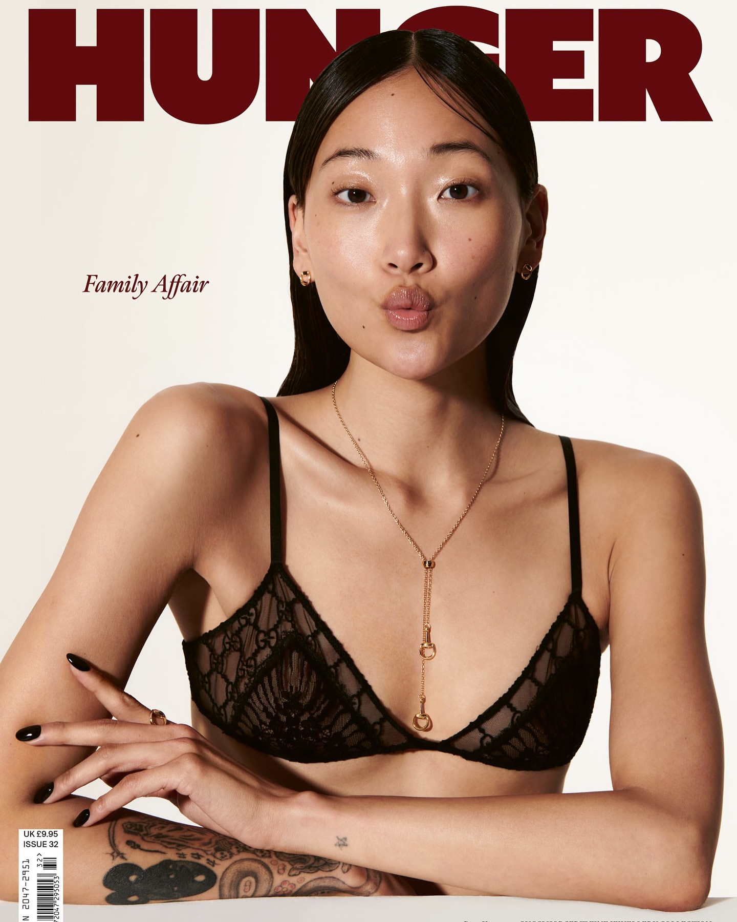 Asian woman poses in a black bra and necklace for a fashion magazine cover. Hunger magazine logo and text 'Family Affair' visible.