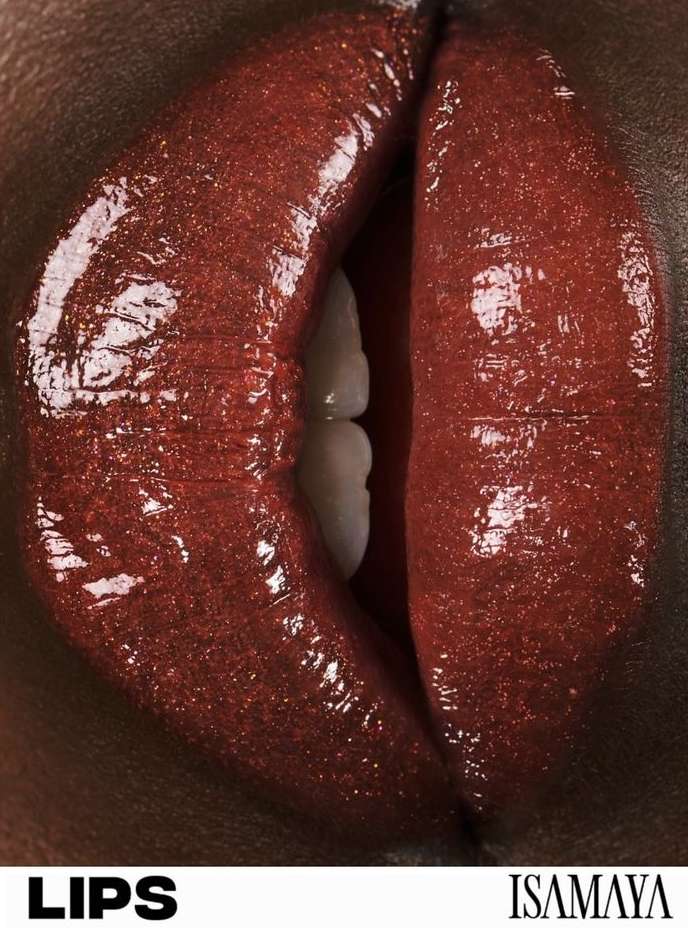 Macro close-up of glossy lips with rich, red-brown lipstick. Focus on texture and makeup artistry in a studio setting, showcasing cosmetic beauty.