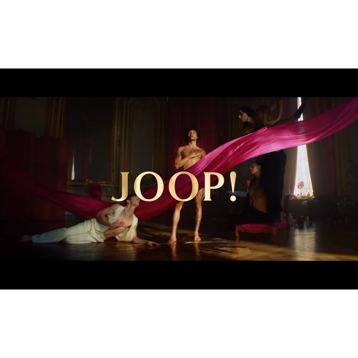 Fashion ad featuring four slender adult humans in a luxurious room with gold trim and pink fabric and the wordmark JOOP!