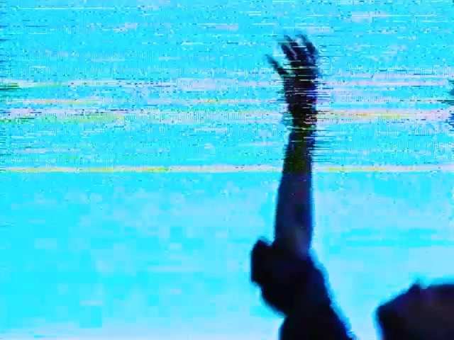 Abstract shot of a raised hand against a blue digital display with horizontal glitch lines and a silhouetted arm and head.