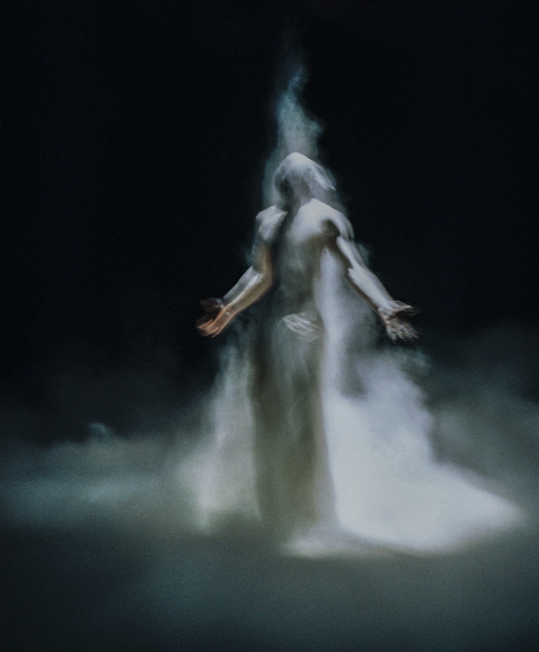 Abstract ethereal figure in white smoke against a dark background, with arms outstretched in a gesture of reaching or offering.