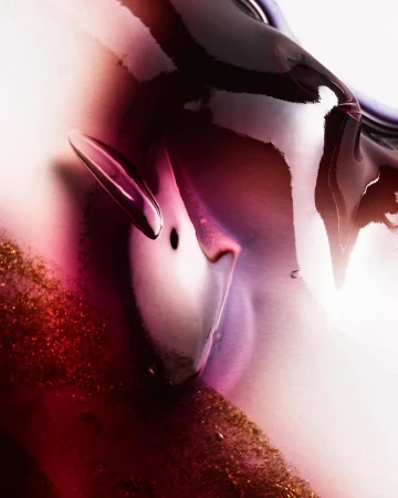 Abstract close-up of a viscous liquid with glossy surface in shades of deep burgundy, light purple, gold glitter, and translucent white.
