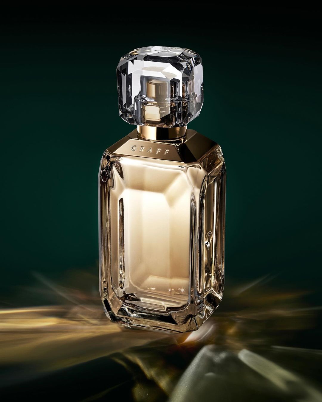 Elegant perfume bottle on a reflective surface against a dark green backdrop, showcasing luxury and sophisticated design.