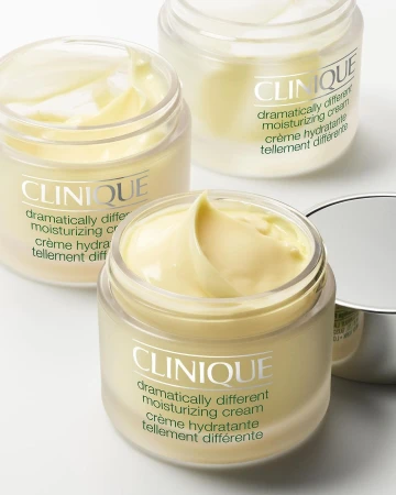 Three jars of Clinique Dramatically Different moisturizing cream with their product names visible. Beauty and skincare product shot. 