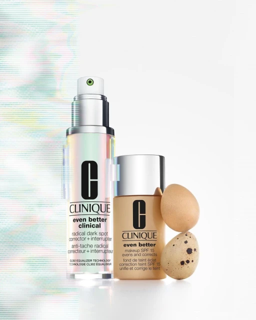 Clinique 'Even Better' skincare products: a clinical dark spot corrector and makeup with SPF 15, alongside two chicken eggs.
