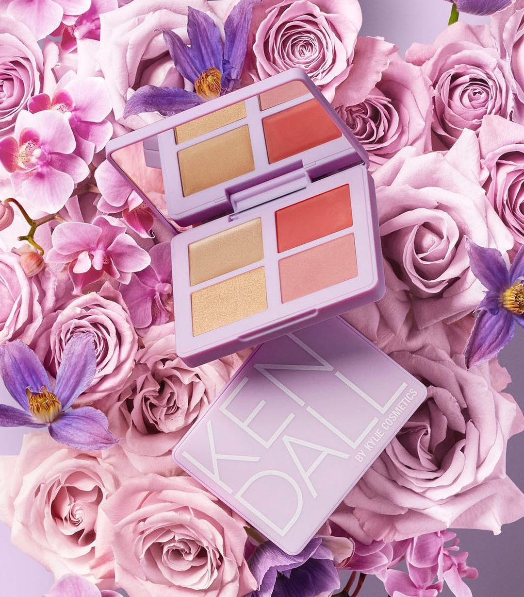 Kylie Cosmetics' Kendall palette atop pink roses, showcasing neutral and coral shades for beauty and fashion visuals.