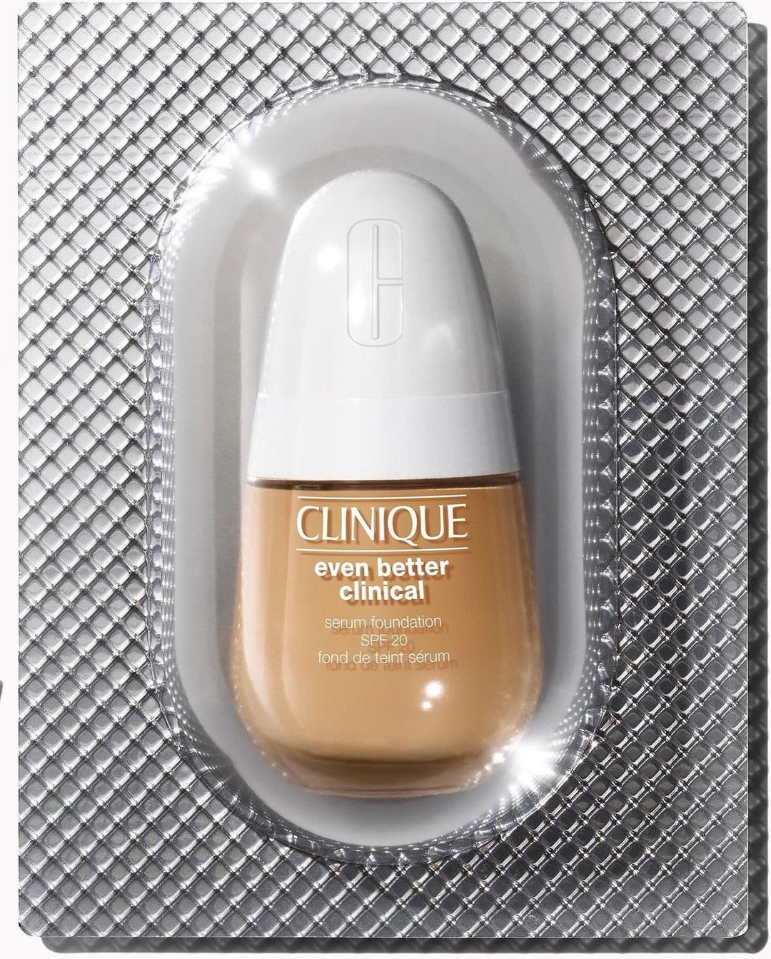 Clinique Even Better Clinical serum foundation in a silver blister pack. White cap, tan foundation color. Product shot for beauty.