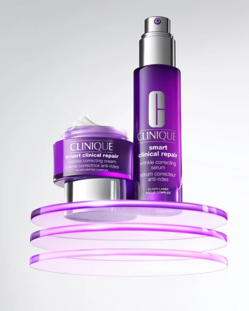 Clinique skincare product set on a translucent purple platform. Includes a jar of wrinkle correcting cream and a bottle of serum.
