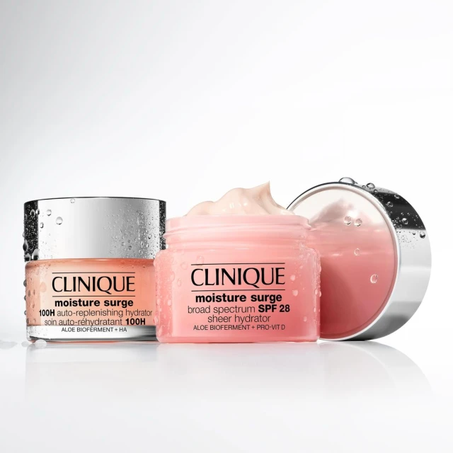Two jars of Clinique Moisture Surge moisturizer are displayed against a white background, one with a silver lid and one pink.