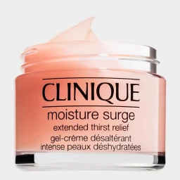 Close-up product shot of a Clinique Moisture Surge gel-creme jar with a curved swatch of peach-colored gel resting on the open rim against a clean white background.