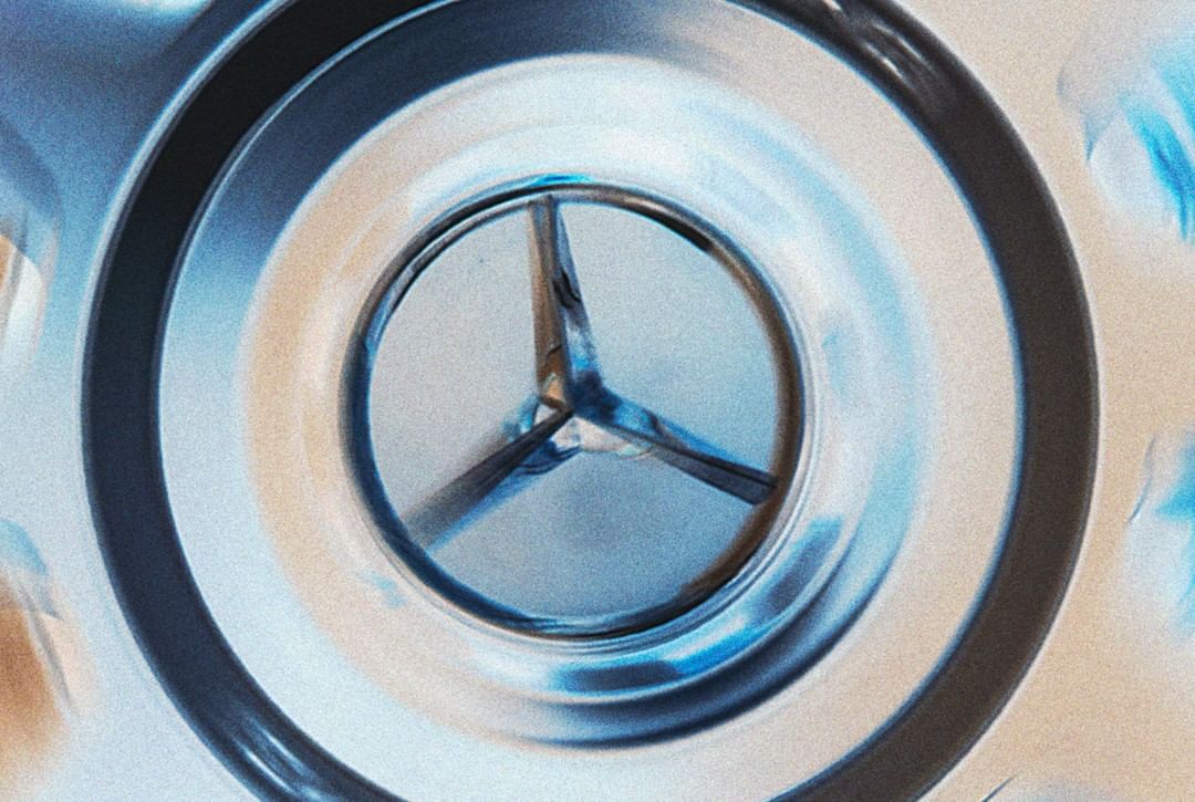 Close-up of a three-pointed metal object with rounded, tubular arms inside a metal casing, captured with a shallow depth of field.