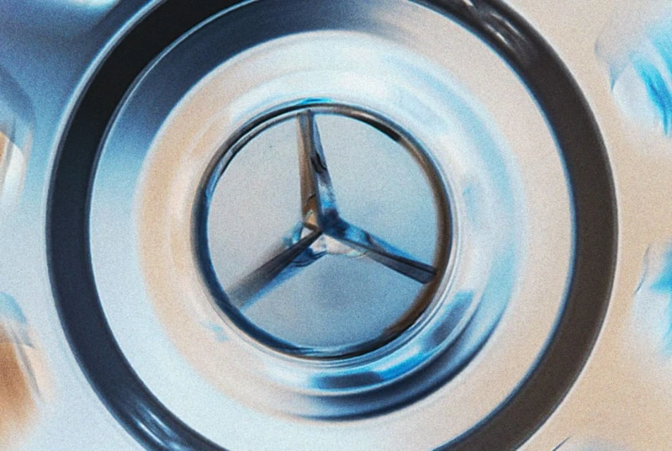 Close-up of a three-pointed metal object with rounded, tubular arms inside a metal casing, captured with a shallow depth of field.