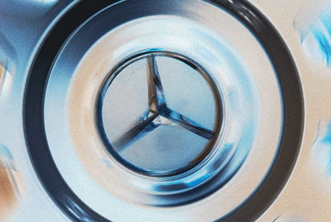 Close-up of a three-pointed metal object with rounded, tubular arms inside a metal casing, captured with a shallow depth of field.
