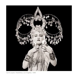 Cyndi Lauper wearing a massive jeweled headdress and layered necklaces by Matthew Rolston