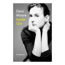 Portrait of Demi Moore with hand resting on chin against a grey backdrop, captured by Matthew Rolston