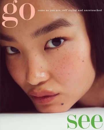 Close-up portrait of an Asian woman with freckles and mole posing for a beauty and fashion editorial magazine cover.
