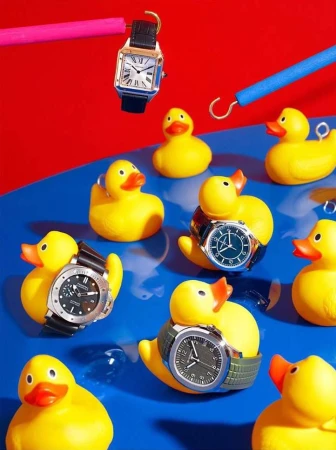 Still life arrangement: Yellow rubber ducks wearing wristwatches float on blue with red background, creating playful contrast.