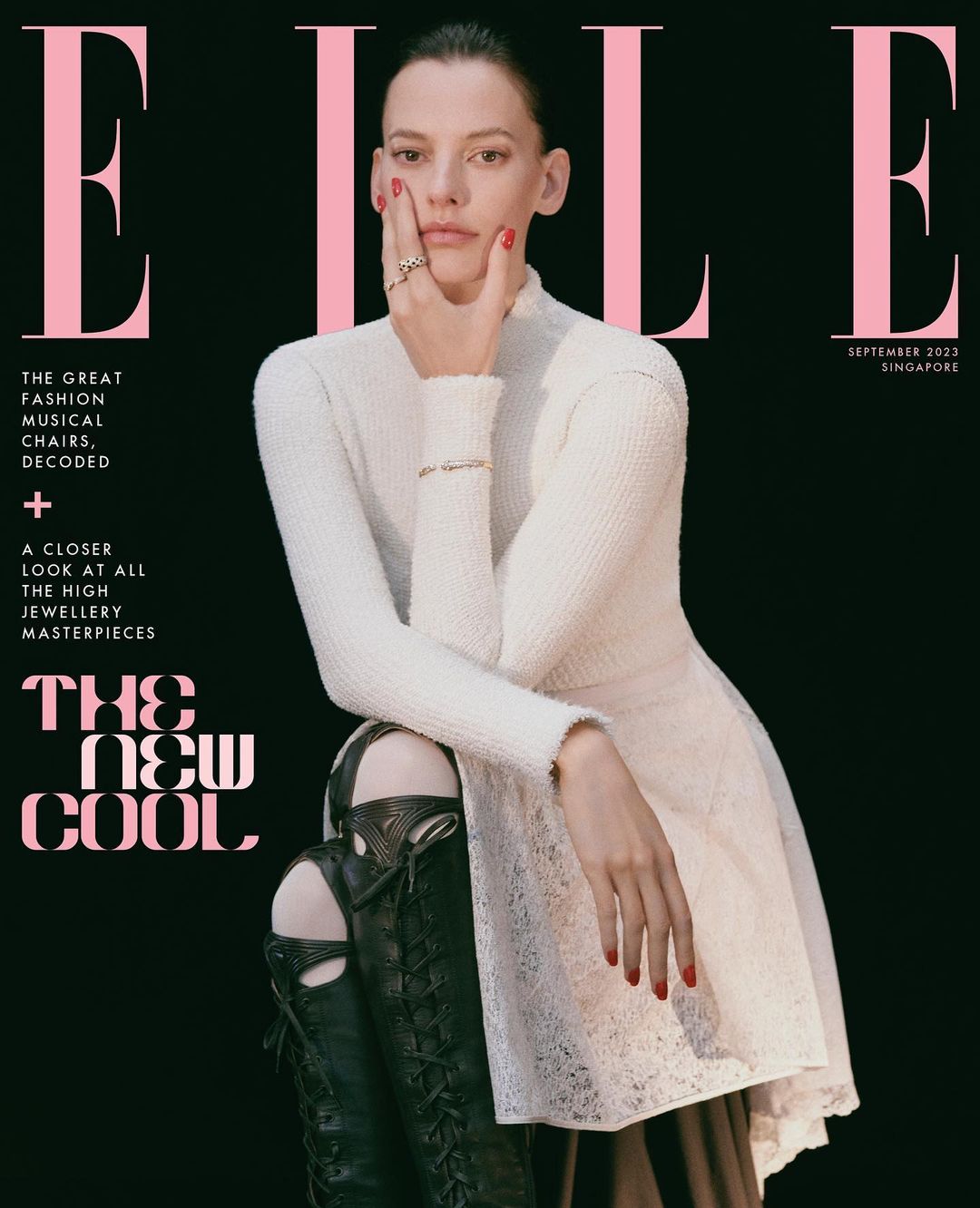 Elle magazine cover featuring a model in a white dress and black boots against a black background, September 2023 Singapore edition.