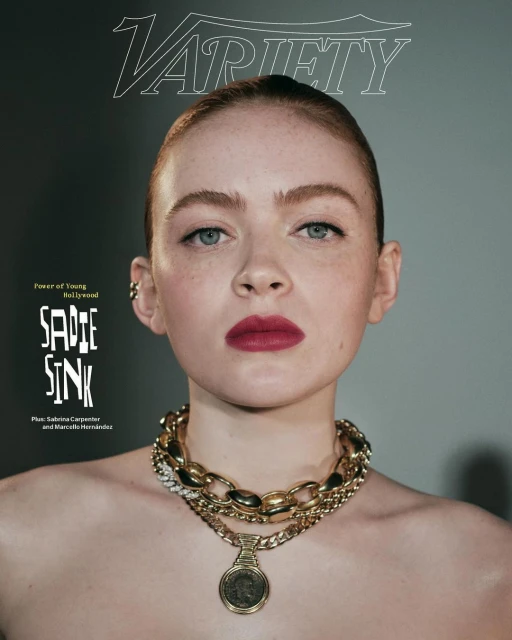 Close-up portrait of Sadie Sink on a Variety magazine cover, adorned with layered gold necklaces. Dark red lipstick accentuates her look.