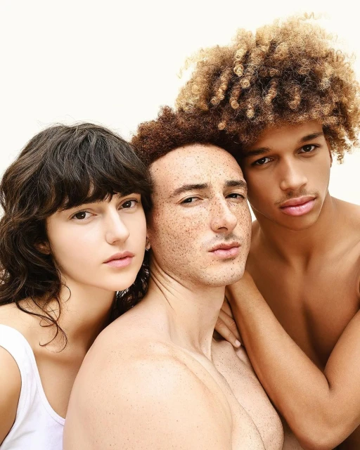 Portrait of three diverse young adults with distinctive hairstyles against a clean white background, emphasizing natural beauty and textures.