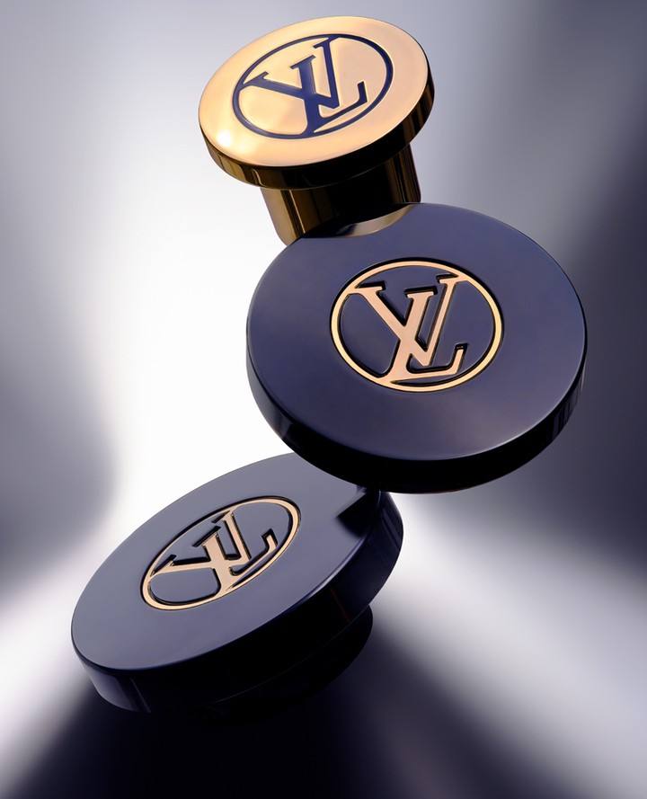 Luxury product shot: two-tone perfume bottles with the Louis Vuitton logo. Gold and navy blue create a sleek, high-end aesthetic.