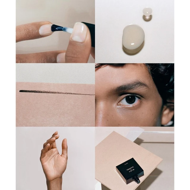 Close-up beauty still life featuring a manicured hand applying clear nail polish, skincare product drop, eye detail, perfume.