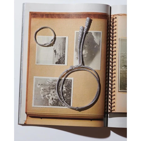 Photograph of two circular bracelets and a rope displayed on pages of a scrapbook with photos; the theme is jewelry presentation.