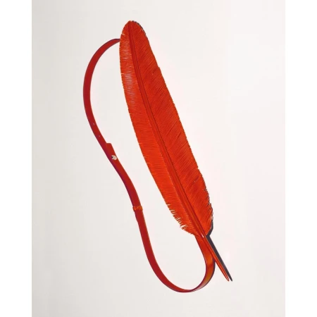 An orange feather with a strap attached to its base, presented on a white backdrop to showcase the material and design.