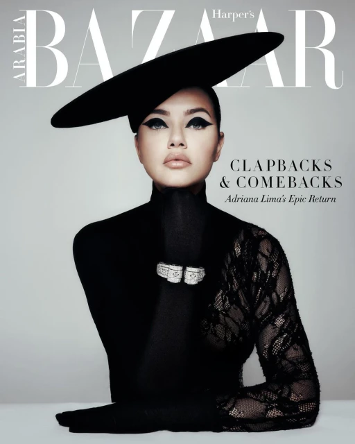 Cover of Harper's Bazaar Arabia featuring a woman wearing a black hat and lace sleeve, posing against a grey background.