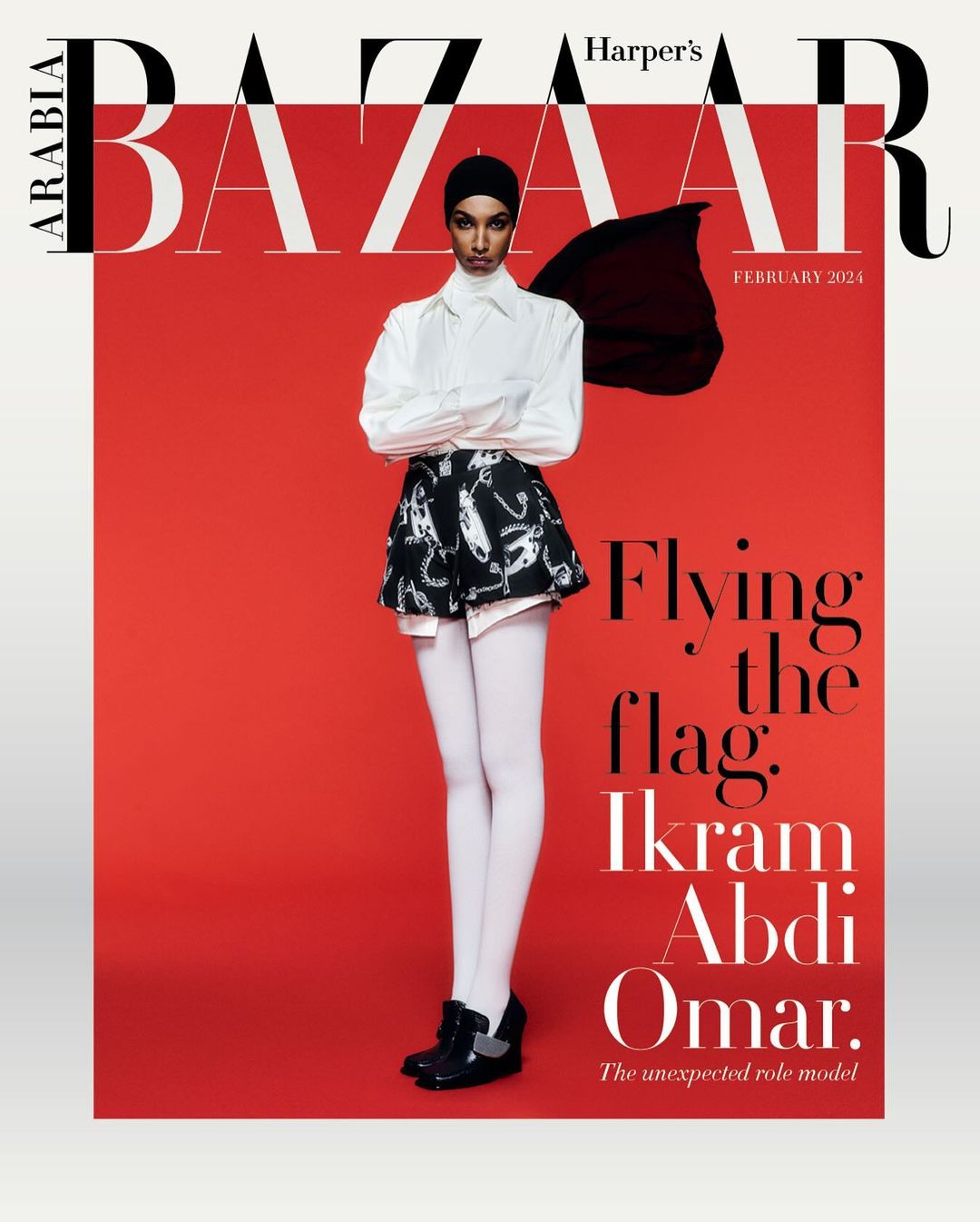 Harper's Bazaar Arabia February 2024 cover featuring a fashion model wearing a white shirt, patterned shorts, white tights, and black flats.