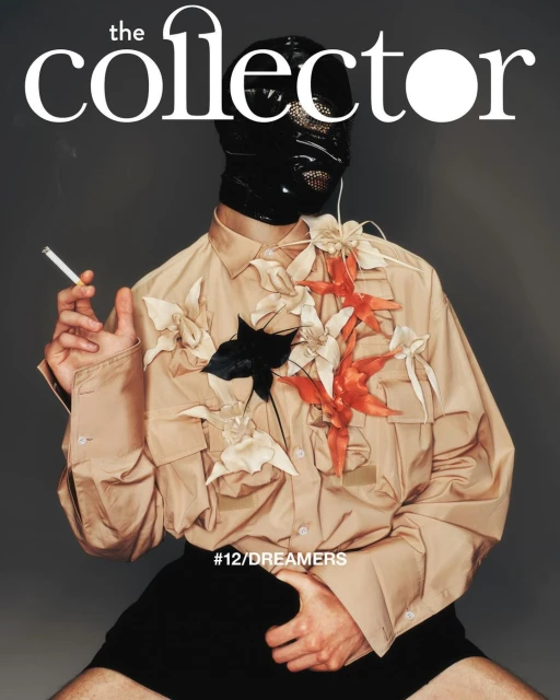 Magazine cover featuring a person in a beige shirt and black balaclava, adorned with floral embellishments, holding a cigarette.