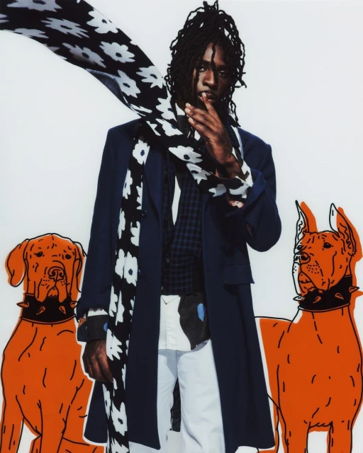 Stylish male model in coat, floral scarf poses with orange cartoon dog graphics on a white backdrop, fashion editorial photography.