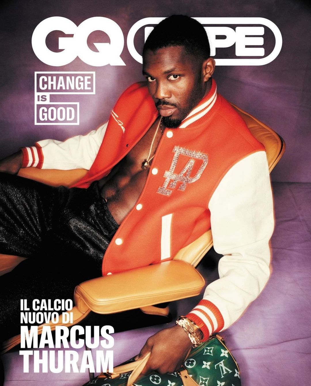 GQ magazine cover featuring Marcus Thuram in a red and white jacket, seated and holding a green Louis Vuitton bag.