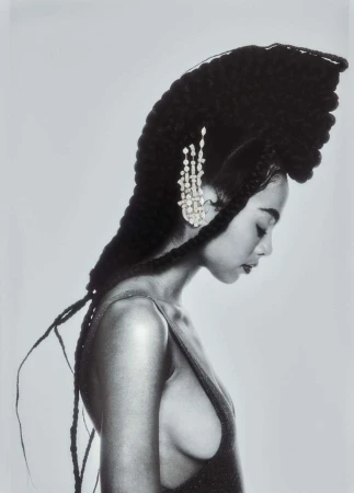 Monochrome portrait of a woman with an elaborate sculpted braided hairstyle and sparkling hair ornament
