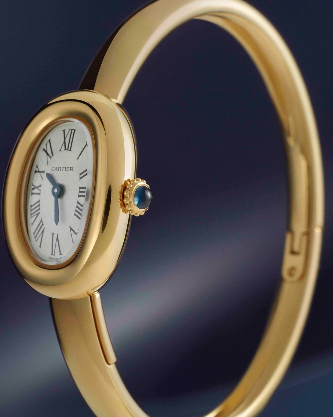 Elegant close-up shot of a gold Cartier wristwatch with a white face and black Roman numerals, showcasing its design and craftsmanship.