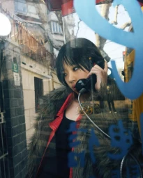 A woman in a furry coat inside a phone booth, photographed by Mauricio Candela
