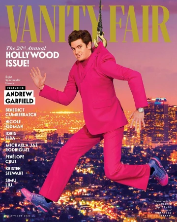 Andrew Garfield on the cover of Vanity Fair's Hollywood issue, suspended mid-air in a pink suit against a city skyline at night.