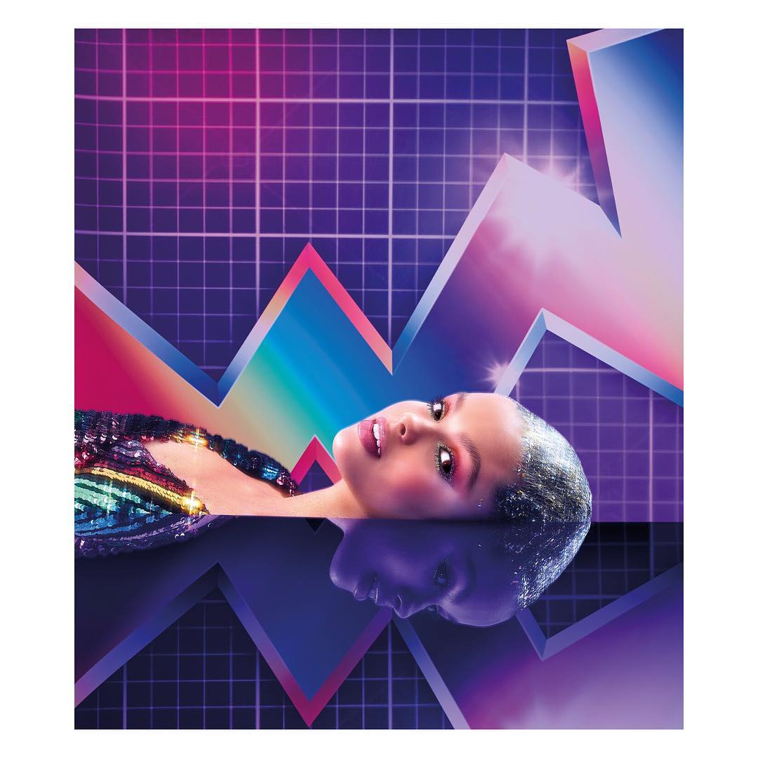 Glamorous woman in a sequined top laying against a neon grid background and reflected in a dark surface, creating a striking, retro aesthetic.
