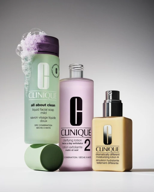 Clinique skincare product bottles sit together in a studio shot, displaying a variety of lotions and soaps in their original containers.